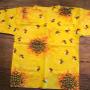 Blouse in dominating sunlight yellow, with organic patterns in richer colors