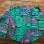 A blouse in mild green with large imaginative circles