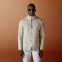 This light brown shirt-jacket is cut to a relaxed fit — easy through the chest and shoulders with a clean, unstructured silhouette — and features a stand collar, patch pockets, and a four-button fastening.